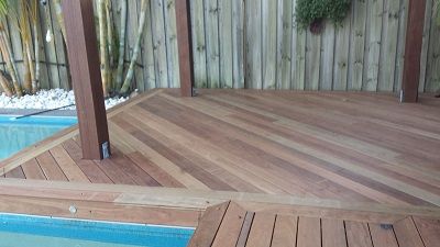 A timber deck, next to a pool, with Iron bark Iconic timber used in different lines, perfect for relaxing after having a swim